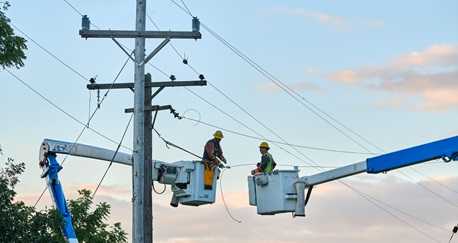 Consumers energy workers on bucket trucks